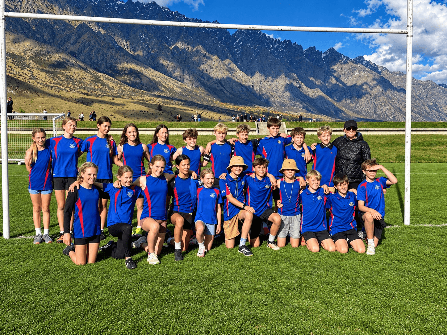 An Arrowtown School sports team in front of the mountains